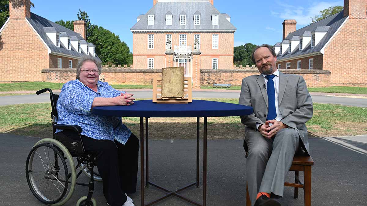 Ian Ehling (right) appraises a 1597 Leonard & Thomas Digges book, in Williamsburg, VA. ANTIQUES ROADSHOW “Colonial Williamsburg, Hour 1” airs Monday, May 9 at 8/7C PM on PBS. Photo by Meredith Nierman for GBH, (c) WGBH 2022.