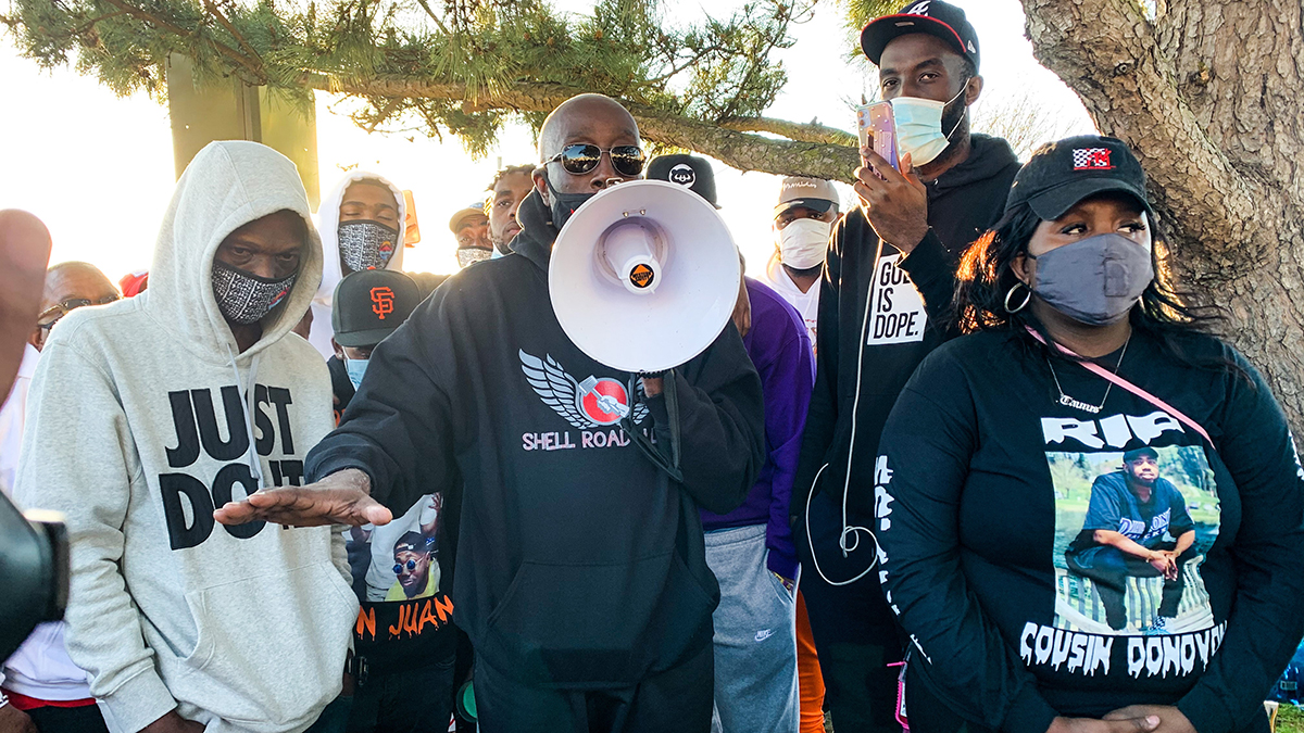 Photo by Mechelle Hankerson. Donovon Lynch's family, including his father Wayne (center), have called for a federal investigation into the 25-year-old's death.