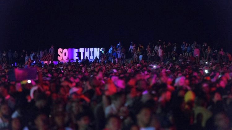 Photo by Ryan Murphy. A view of the crowd after dark at Something in the Water in 2019.