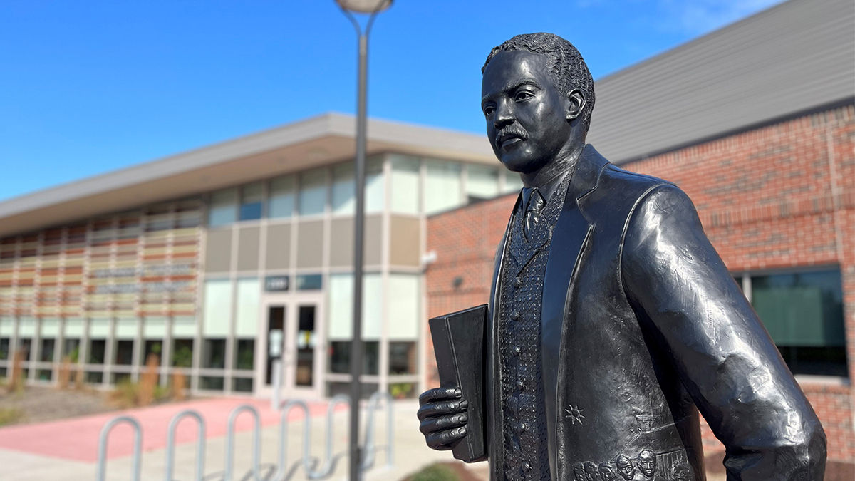 Photo by Ryan Murphy. A bronze statue of educational leader Richard A. Tucker was erected in front of Norfolk’s Richard A. Tucker Memorial Library in Campostella.