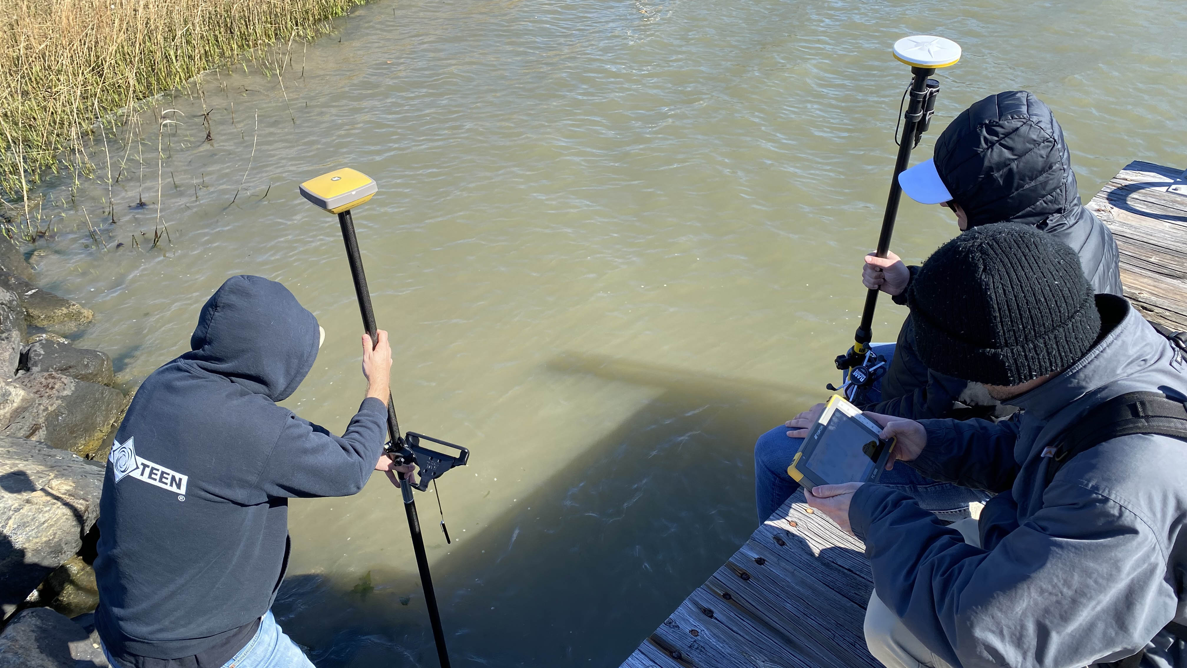 A team from Old Dominion University checks on a flood sensor in the Elizabeth River on March 15. (Image: Katherine Hafner)