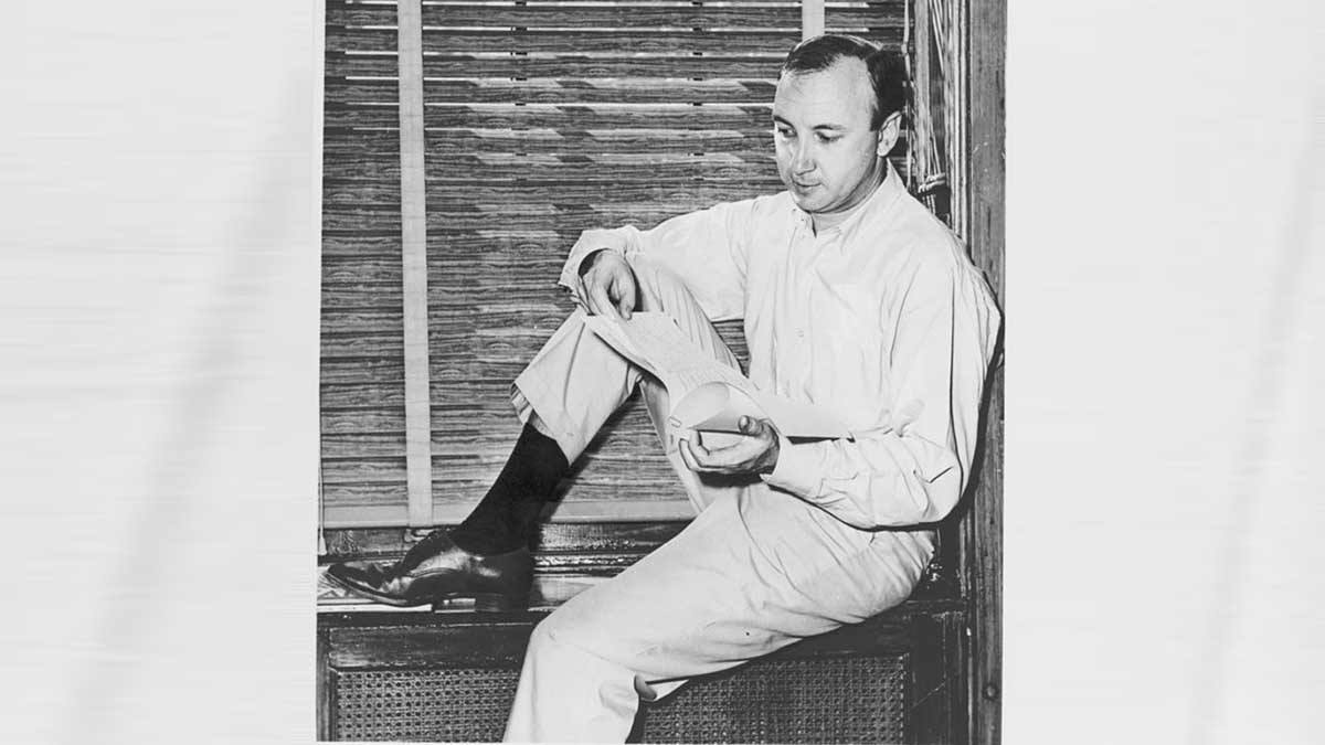 Mr. Neil Simon, author, sitting on windowsill at home pouring over a script of play he wrote.