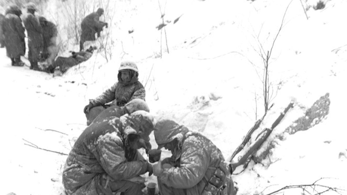 Photo By U.S. Marines. First Marine Division personnel stop for a brief rest during the fighting at the Chosin Reservoir in Korea, December 1950. A member of this division, Pfc. Henry Ellis was killed in this battle just weeks earlier, on November 30.
