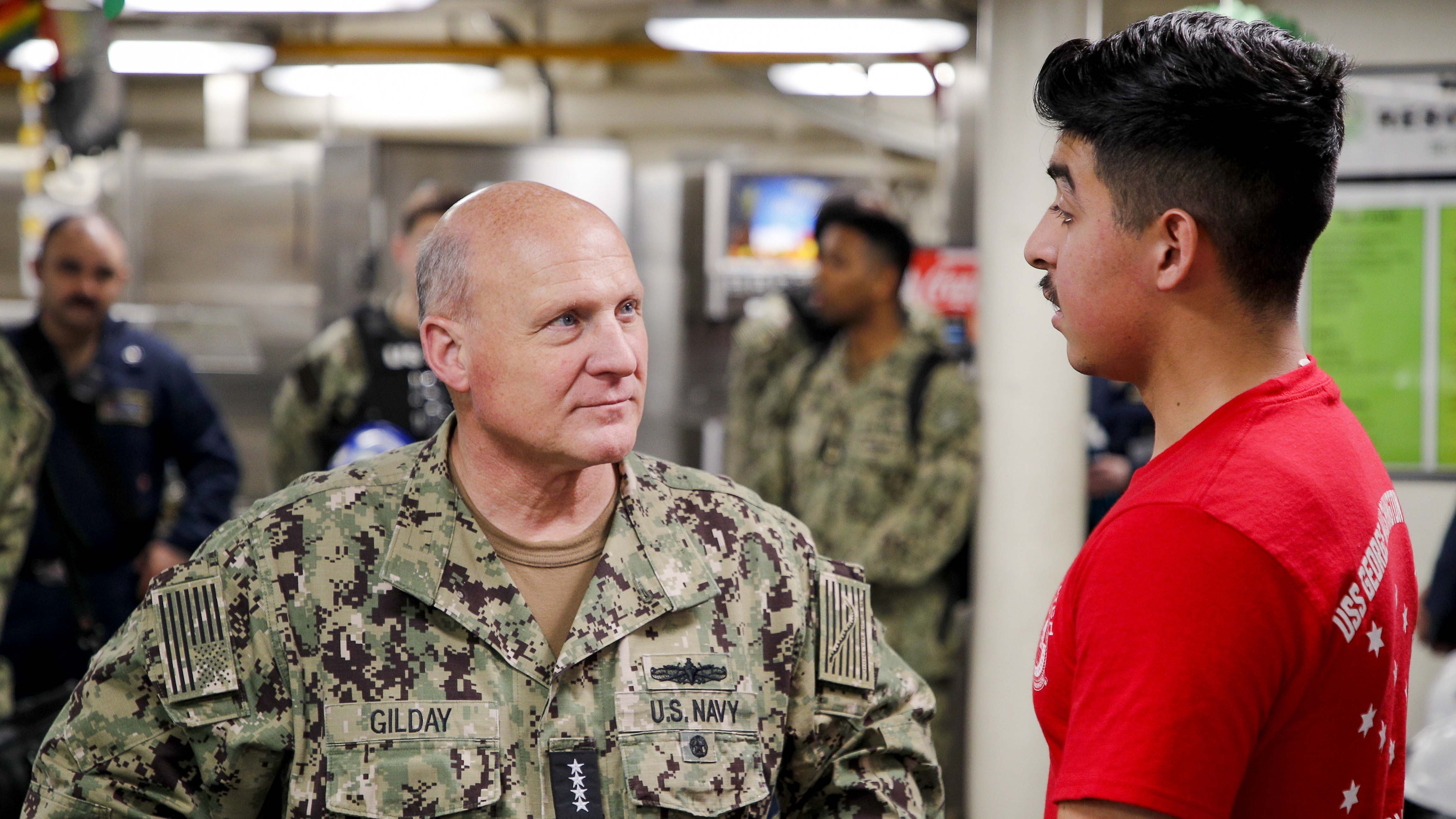 Chief of Naval Operations Adm. Mike Gilday speaks with Airman Juan D. Venegas during a visit aboard the USS George Washington in Newport News. The George Washington is undergoing refueling and complex overhaul at Newport News Shipbuilding. (Image: Department of Defense)
