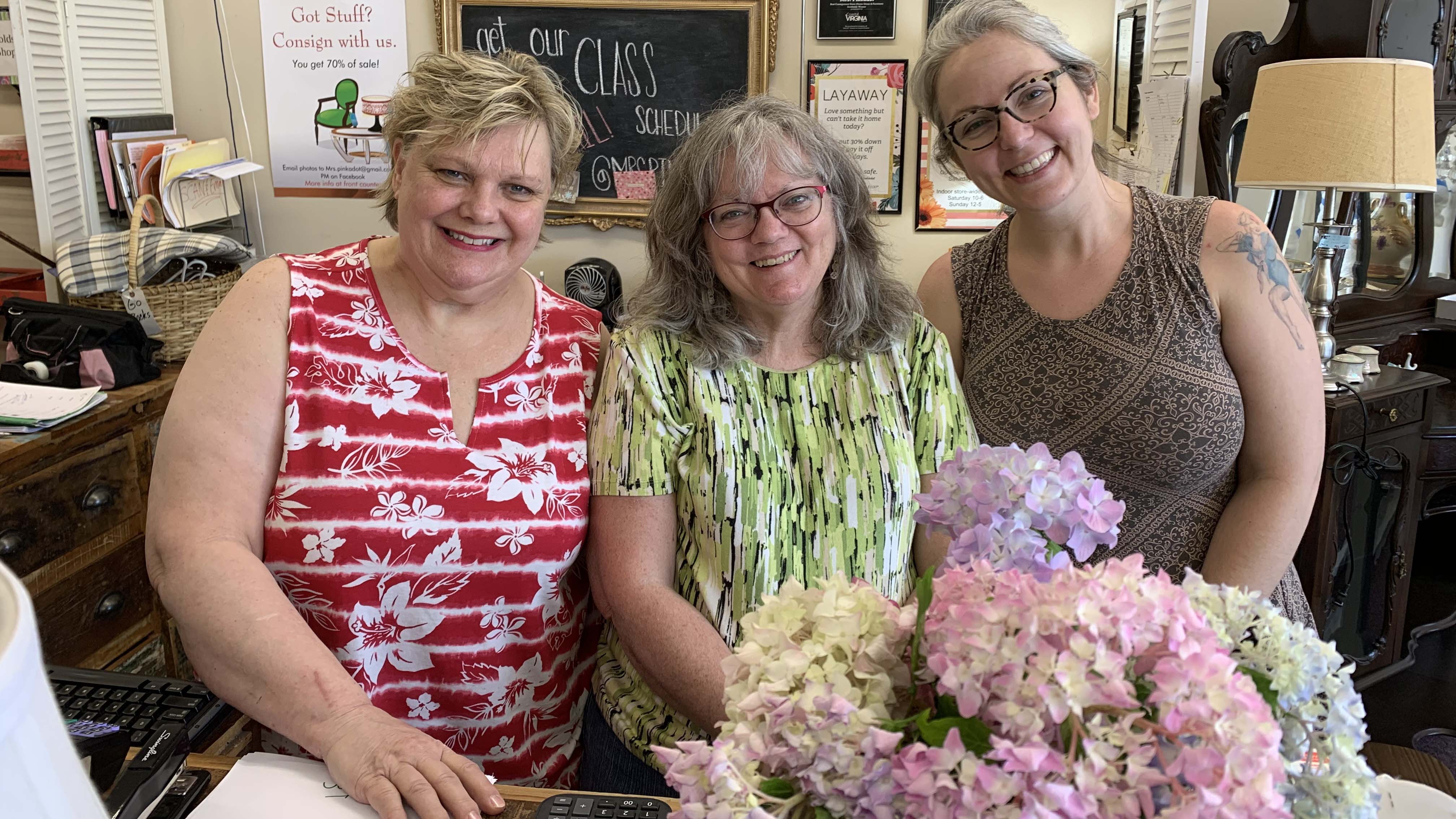 Photo by Gina Gambony, WHRO. From left: Joan Wilkening, Melissa Jones and Erin DuPrey managed online sales while Mrs. Pinkadot was closed. Now they prepare for customers to come back.