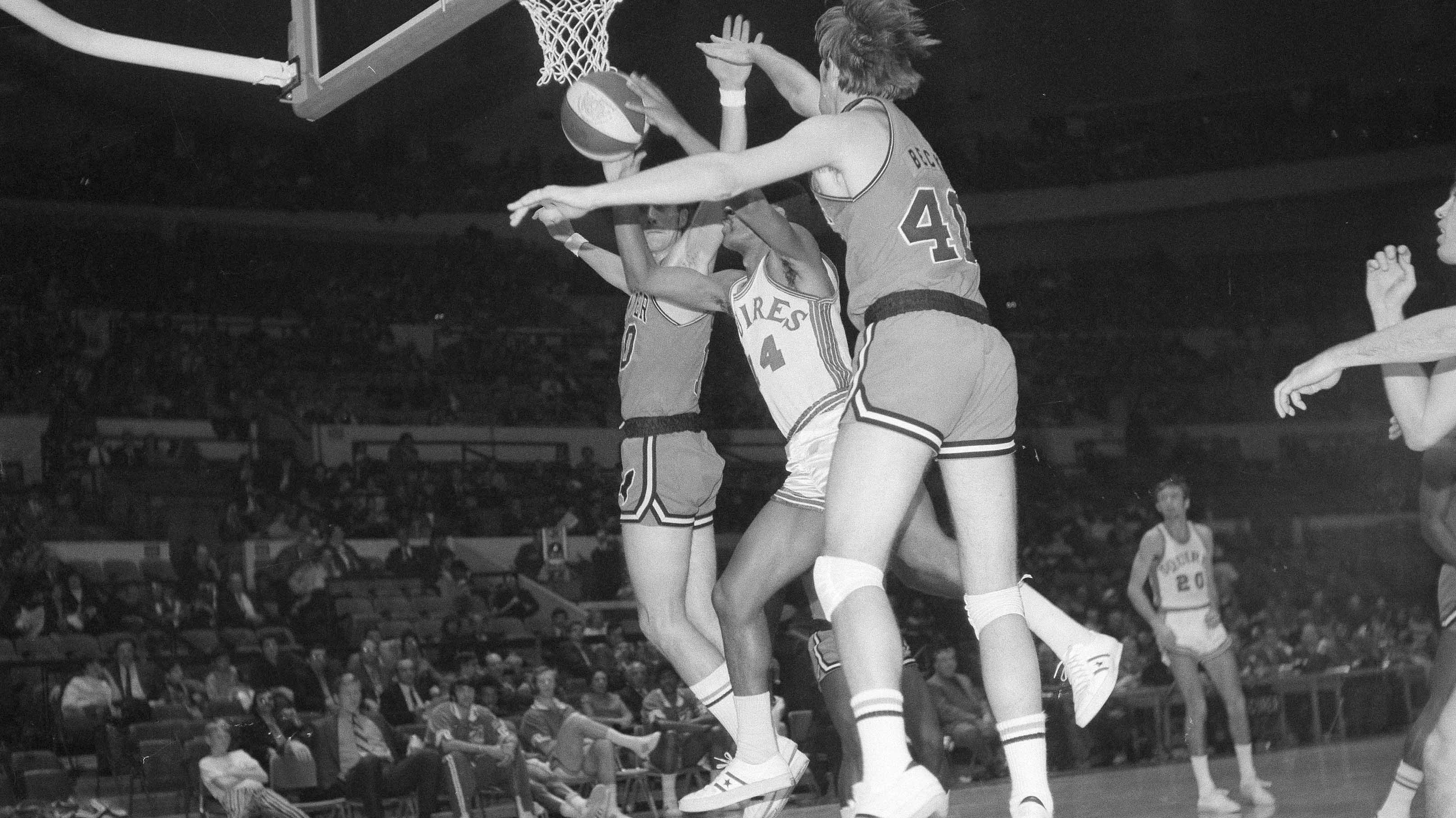 Roland Taylor (14) Virginia Squires reserve, tries to force shot through outstretched arms of Denver Rockets defenders Wayne Chapman (10) and Byron Beck in the second period of game at New York's Madison Square Garden, Dec. 10, 1970. (AP Photo)