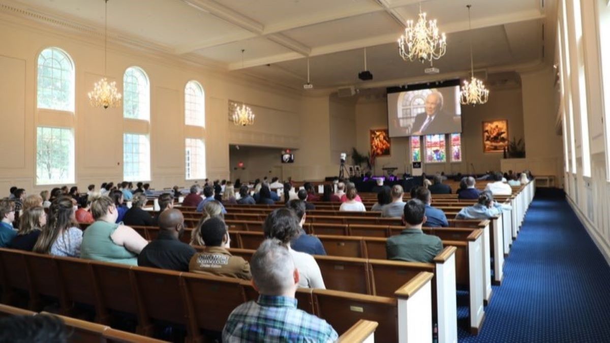 Faculty, staff and students gather in the Regent University Chapel to watch a broadcast of a retrospective of university founder Pat Robertson’s life. (Photo: Ryan Murphy)
