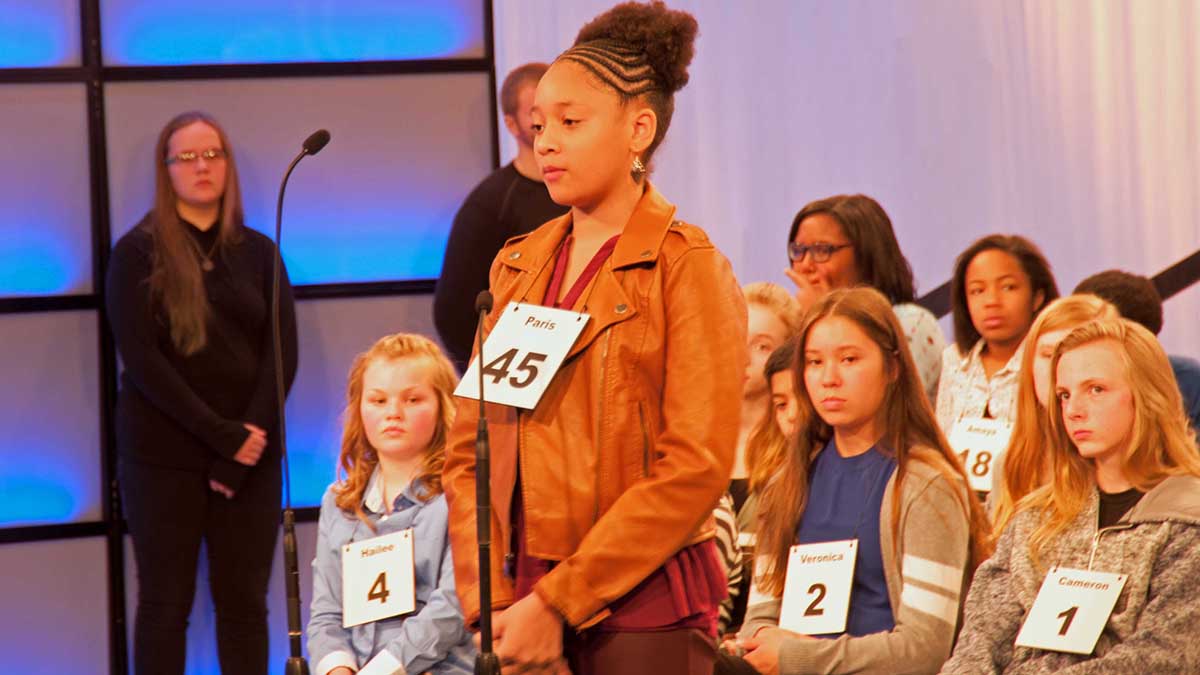 A student competes in a previous regional spelling bee.