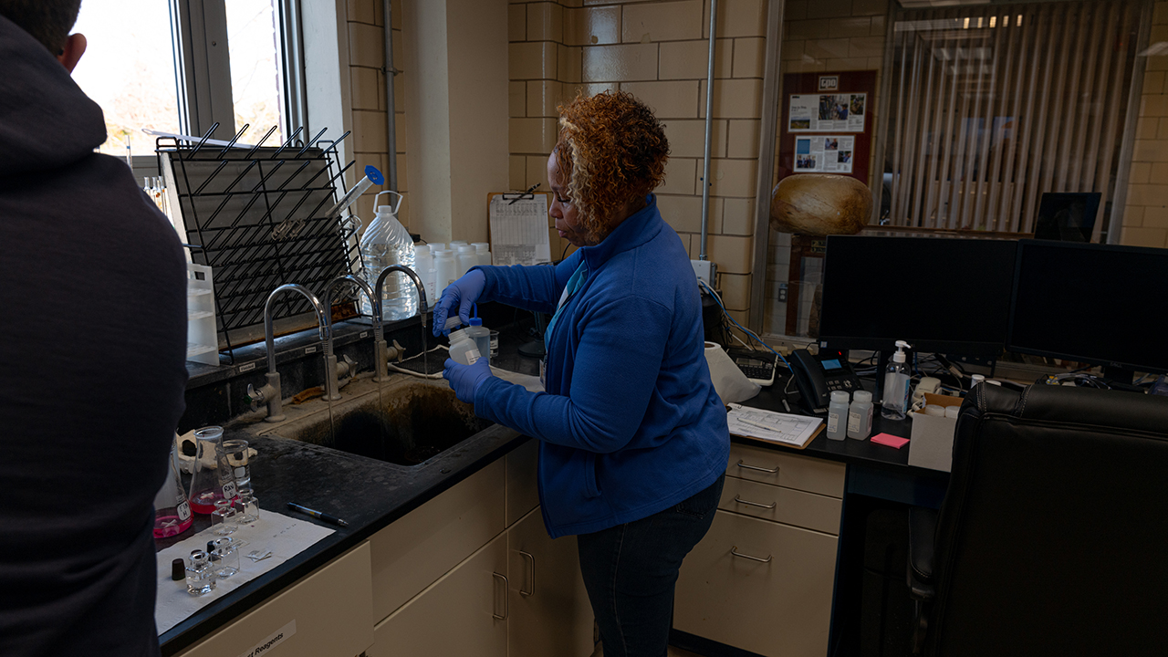 LaFonia Thornton, who works for the Southeast Rural Community Assistance Project, takes water samples in November at the Percy D. Miller Water Treatment Plant in Middletown, Virginia, on November 9, 2022. Thornton was testing for PFAS contamination as part of an effort by the Virginia Department of Health to better understand how widespread the problem was.