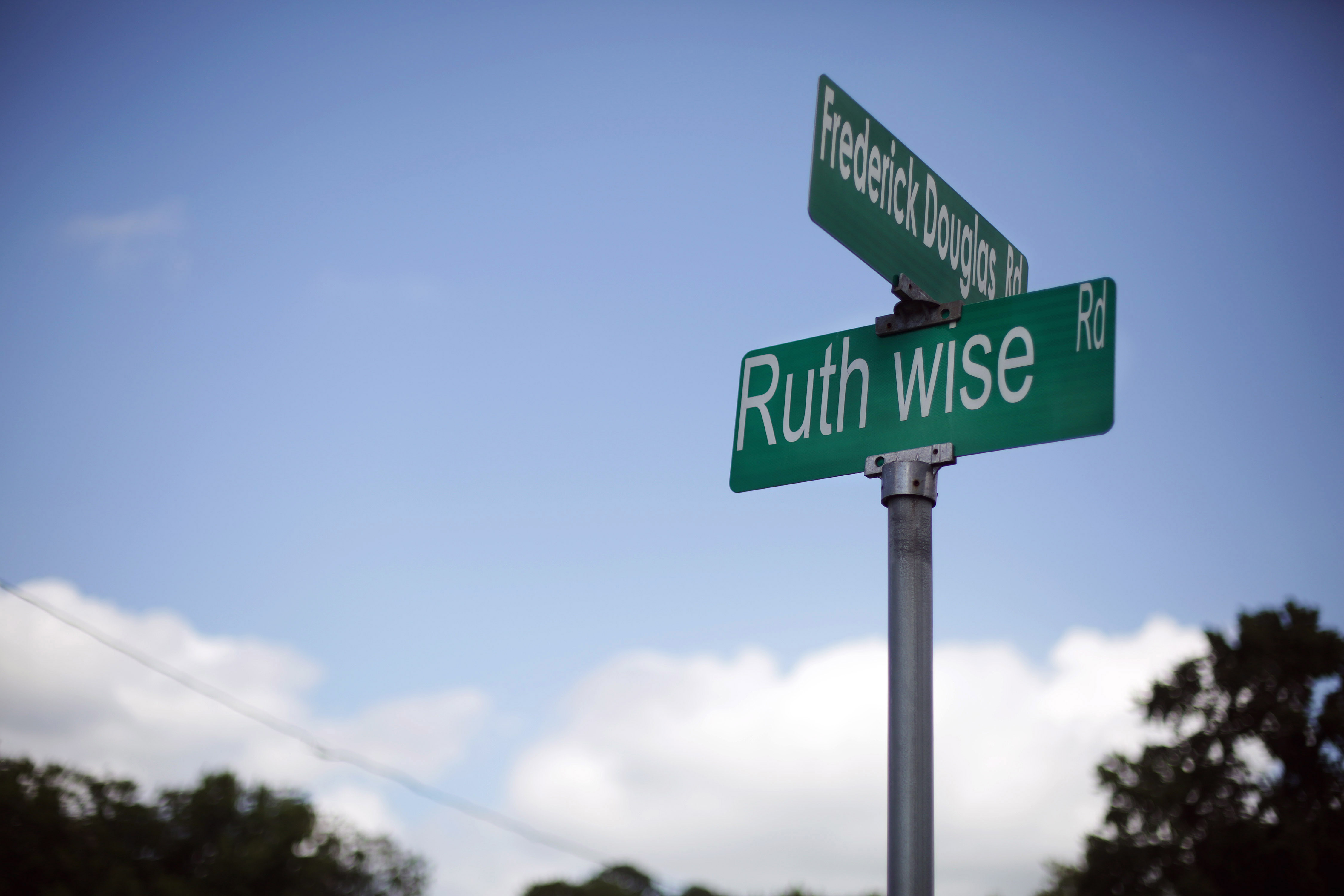 A street sign in the New Road Community bears the name of Ruth Wise, who with her family started the New Road Community Development Group in 1992. Like many residents here, WiseÕs family is descended from people who were once enslaved on this land. Photographed on Sept. 13, 2022.